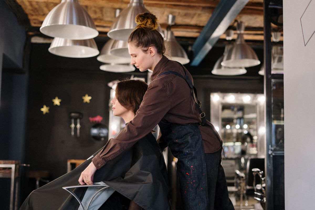 Hair stylist caring for a client in a salon